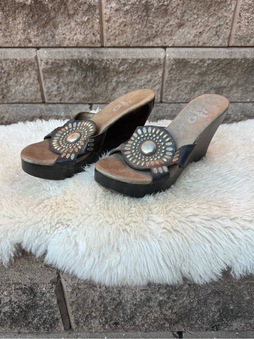Cordani Brown and Black Leather Wedge Mules with Decorative Medallion